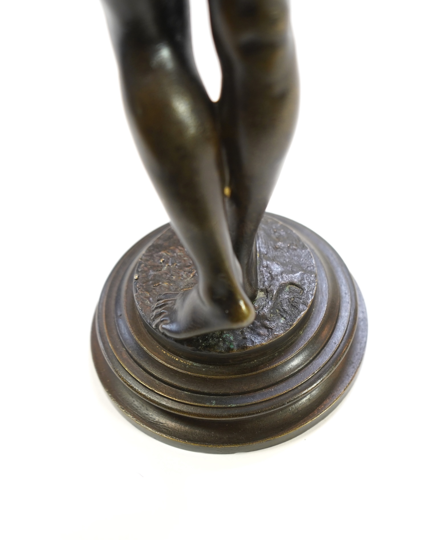 Josef Wind (German, 1864-1889). A patinated bronze of a nude female snake charmer